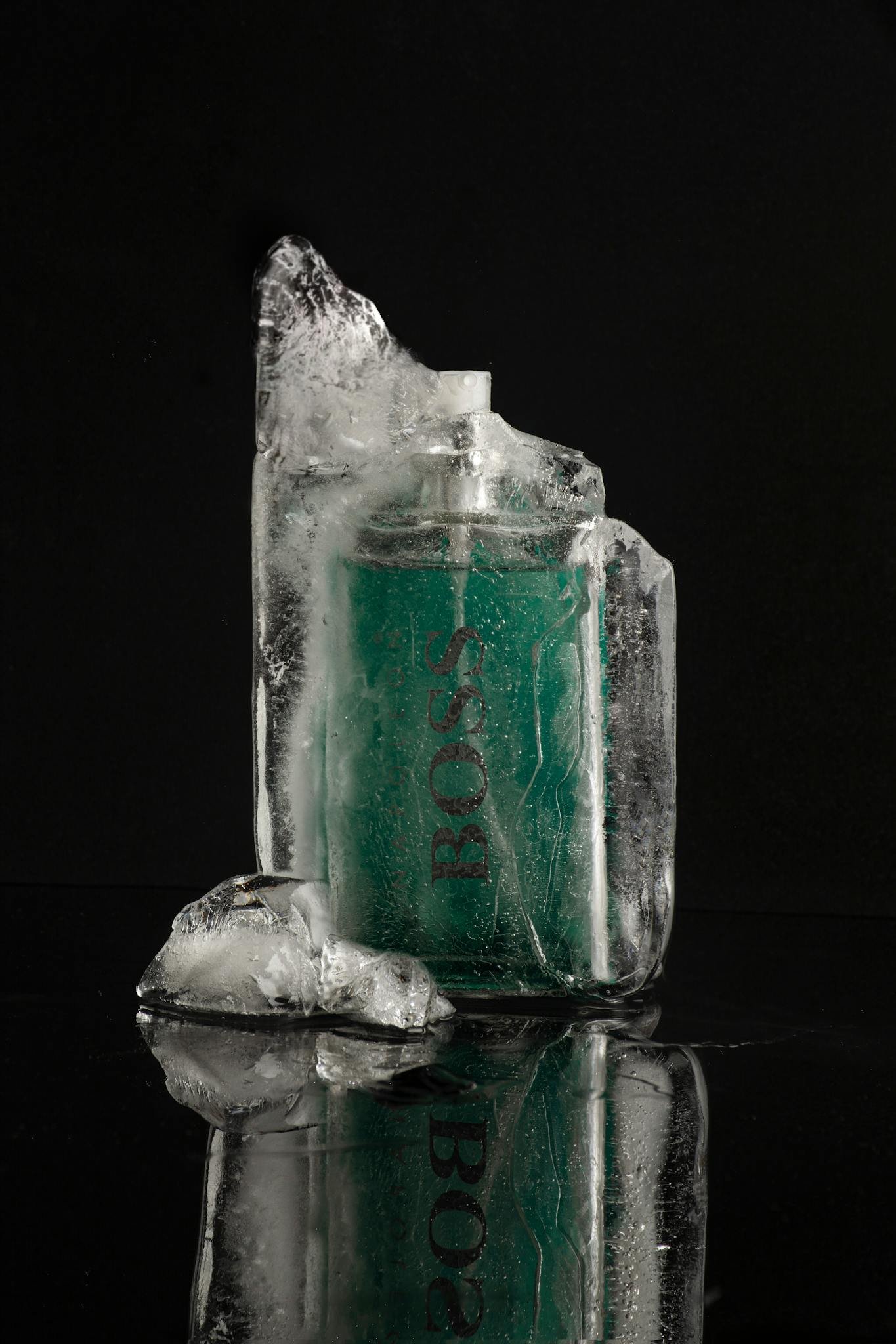 Elegant product shot of a perfume bottle encased in ice, highlighting luxury on a black background.